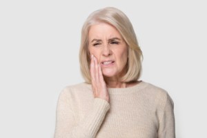 suffering from sudden tooth pain feels unhealthy unhappy need emergency dental help